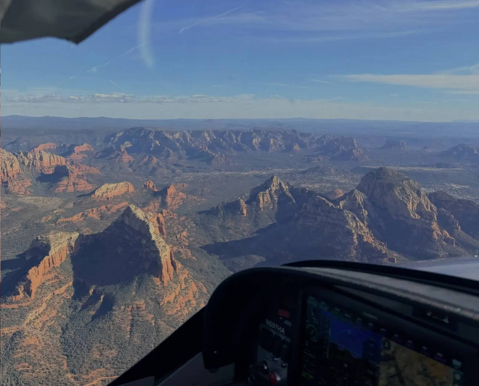 Training aircraft flying over mountainous terrain
